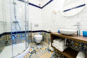 a bathroom with a shower and a toilet and a sink at Apartments & Rooms Matos in Portorož
