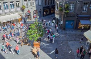 a crowd of people walking on a city street at L'Annexe in Saint Malo