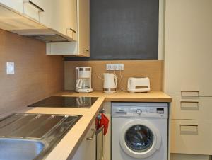 a kitchen with a washer and dryer on a counter at L'Annexe in Saint Malo