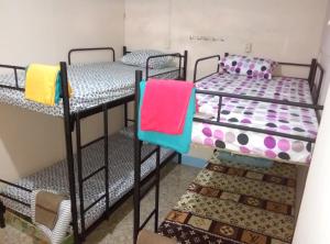 two bunk beds in a dorm room with colorful towels at Jogja Backpacker Home in Yogyakarta