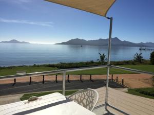 a balcony with a view of the water at Cardwell Beachfront Motel in Cardwell