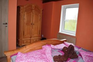 a bedroom with a bed and a dresser at Hrazdeny statek Mytinka in Mýtinka
