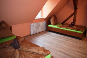 a room with two bunk beds in a attic at Hrazdeny statek Mytinka in Mýtinka