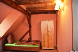 a attic room with a bed and a door at Hrazdeny statek Mytinka in Mýtinka