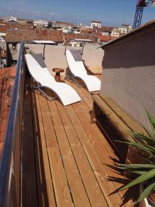 a row of white benches sitting on top of a roof at L'Atypique in Sète