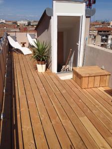 a wooden deck on top of a roof at L'Atypique in Sète