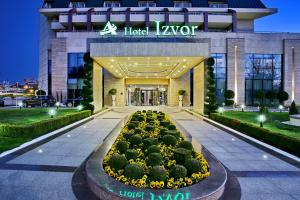 a hotel lobby with a garden in front of it at A Hoteli - Hotel Izvor in Arandelovac