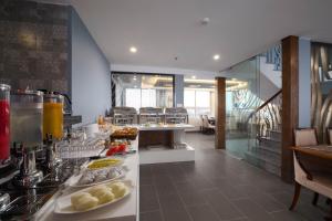 a kitchen with a buffet of food on a counter at Bonsella Hotel in Hanoi