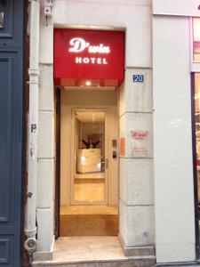 a sign in front of a store with a door open at D'win in Paris
