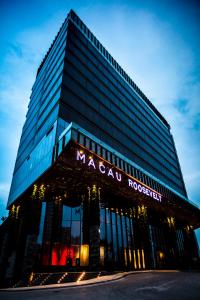 a large building with a macauractor sign on it at The Macau Roosevelt Hotel in Macau