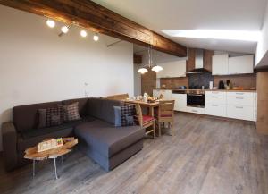 a living room and kitchen with a couch and a table at Unterhofgut in Goldegg