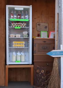 an open refrigerator filled with food and drinks at Unterhofgut in Goldegg