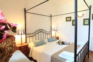 a bedroom with a large bed with a canopy at Fattoria Mongerrate in Isnello