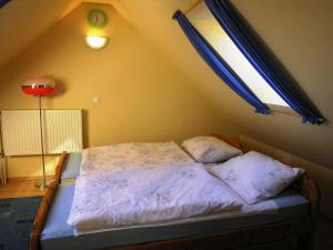 A bed or beds in a room at Christian Apartman