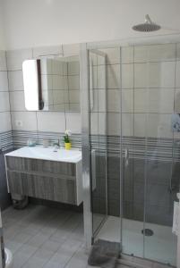 クロトーネにあるLa Fortezzaのバスルーム(洗面台、ガラス張りのシャワー付)