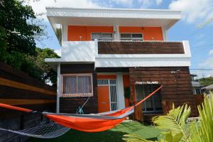 a red hammock in front of a house at South Island in Itoman