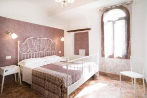 a bedroom with a white bed and a window at Key of Venice Guest House in Venice