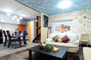 a living room with a couch and a table at South Island in Itoman