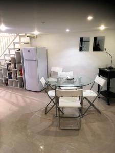 a dining room with a glass table and a refrigerator at Casa vacanza Civita Catania Centro in Catania