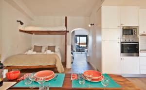 a room with a bed and a table with glasses on it at The Salty Lodge in Lagos