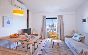 a living room with a table and a couch at The Salty Lodge in Lagos
