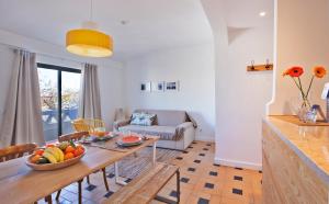 a living room with a table with a bowl of fruit on it at The Salty Lodge in Lagos