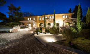 a large house with a driveway in front of it at Country Lodge B&B in Siena