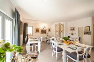 a dining room with white tables and chairs at Country Lodge B&B in Siena
