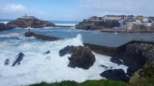 a wave crashing on a rock in the ocean at Hotel La Cuesta in Tapia de Casariego