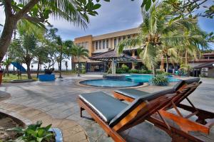 a resort with a pool and a lounge chair at The Jayakarta Anyer in Anyer