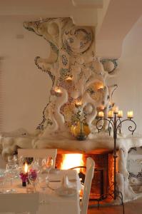 a dining room with a table and a fireplace at Hotel Punta Sur in Tarifa