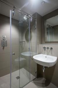 a bathroom with a sink and a glass shower at No.8 Waterloo Street in Birmingham +52 photos