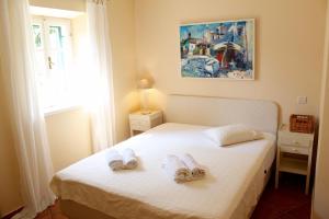 a bedroom with a bed with two towels on it at Villa St Roko - Charme Holidays in Sutivan