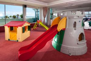 a play room with a slide and a play house at Hotel Mediterraneo in Riccione