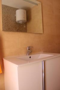 a bathroom with a white sink and a mirror at Panorama Mediterranea in St Paul's Bay