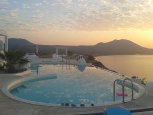 a swimming pool with a view of the water at Kaladi Rock in Avlemonas