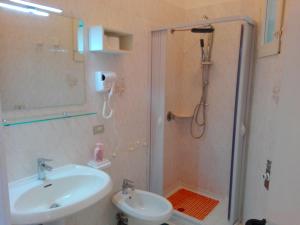 a bathroom with a sink and a shower with a sink at Chiaia Apartments by Caseaponza it in Ponza +16 photos