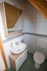 a bathroom with a sink and a toilet at Vulcano Vendégház in Kisapáti +13 photos