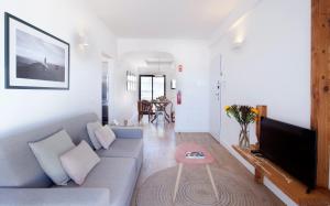 a living room with a couch and a tv at The Salty Lodge in Lagos