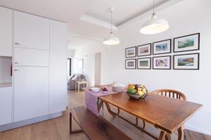 a kitchen and dining room with a wooden table at The Salty Lodge in Lagos
