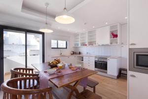 a kitchen with a wooden table and chairs in a kitchen at The Salty Lodge in Lagos
