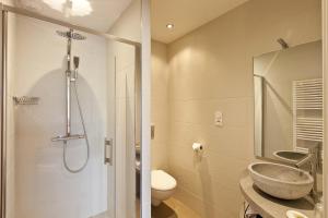 a bathroom with a shower and a sink and a toilet at Hostellerie Saint Germain in Saint-Germain-lès-Arlay +52 photos