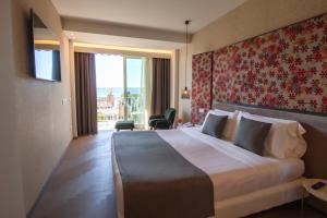 Кровать или кровати в номере Olivi Hotel & Natural Spa