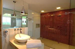 a bathroom with a sink and a glass shower at Le Ville in Ouro Preto +22 photos