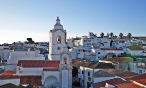 a church in the middle of a city with white buildings at The Salty Lodge in Lagos