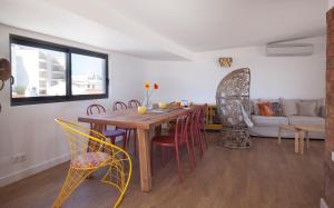 a living room with a wooden table and chairs at The Salty Lodge in Lagos