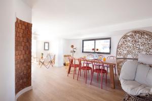 a living room with a dining room table and chairs at The Salty Lodge in Lagos