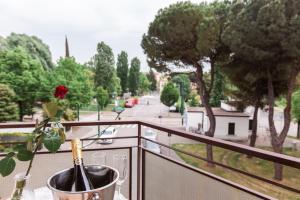 a vase with a rose in it sitting on a balcony at Bongiorno Home Private Free Parking Venice 10' in Marghera