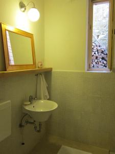 a bathroom with a sink and a mirror and a window at Flori Adriatic in Marezige
