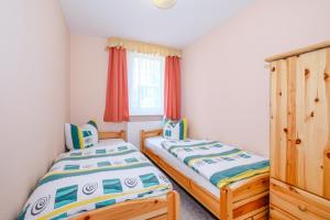 two twin beds in a room with a window at Ferienhaus Harzidyll in Schierke